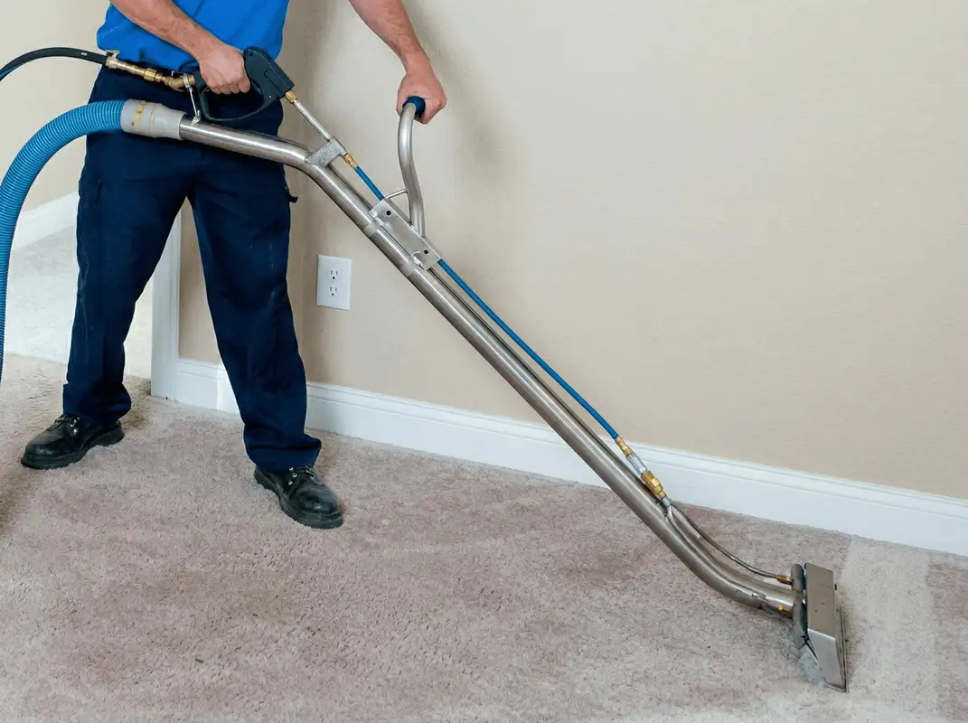 Professional operating a liquid removal machine on a carpeted floor in Tampa, FL